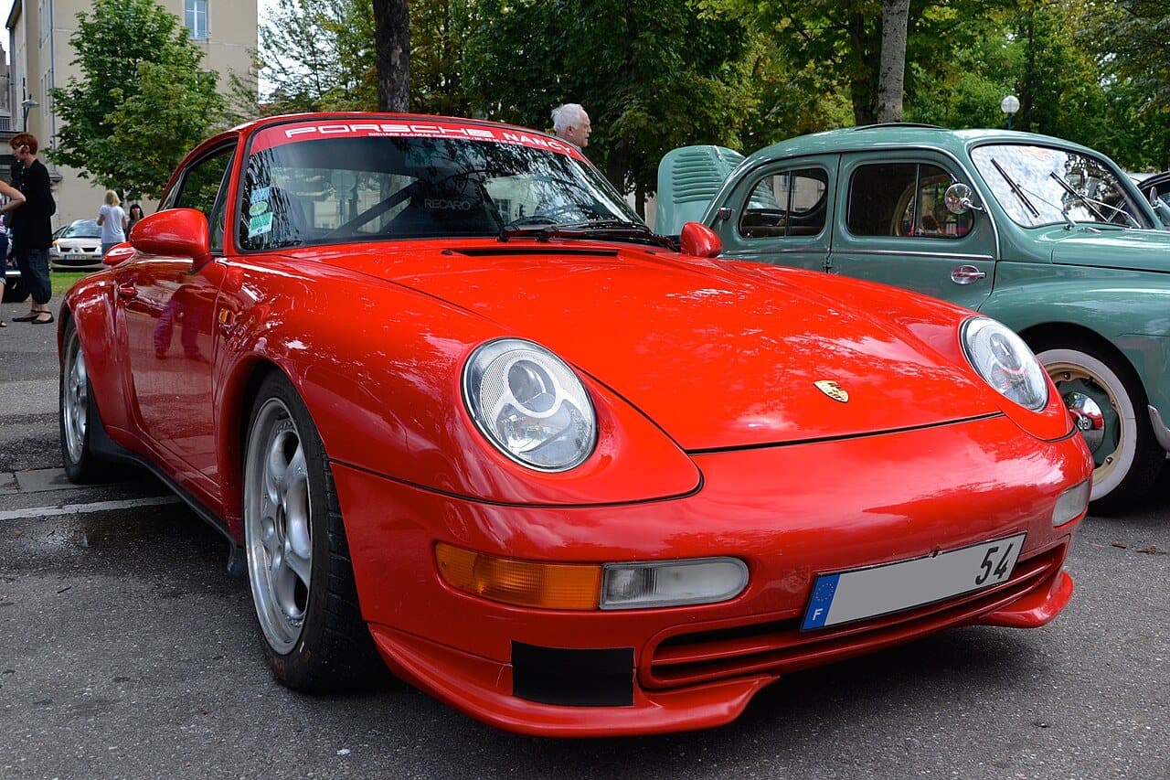 A red Porsche 911, front three-quarter view